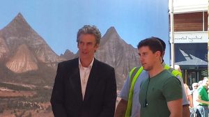 Peter Capaldi with scenery backdrop of mountains and desert.